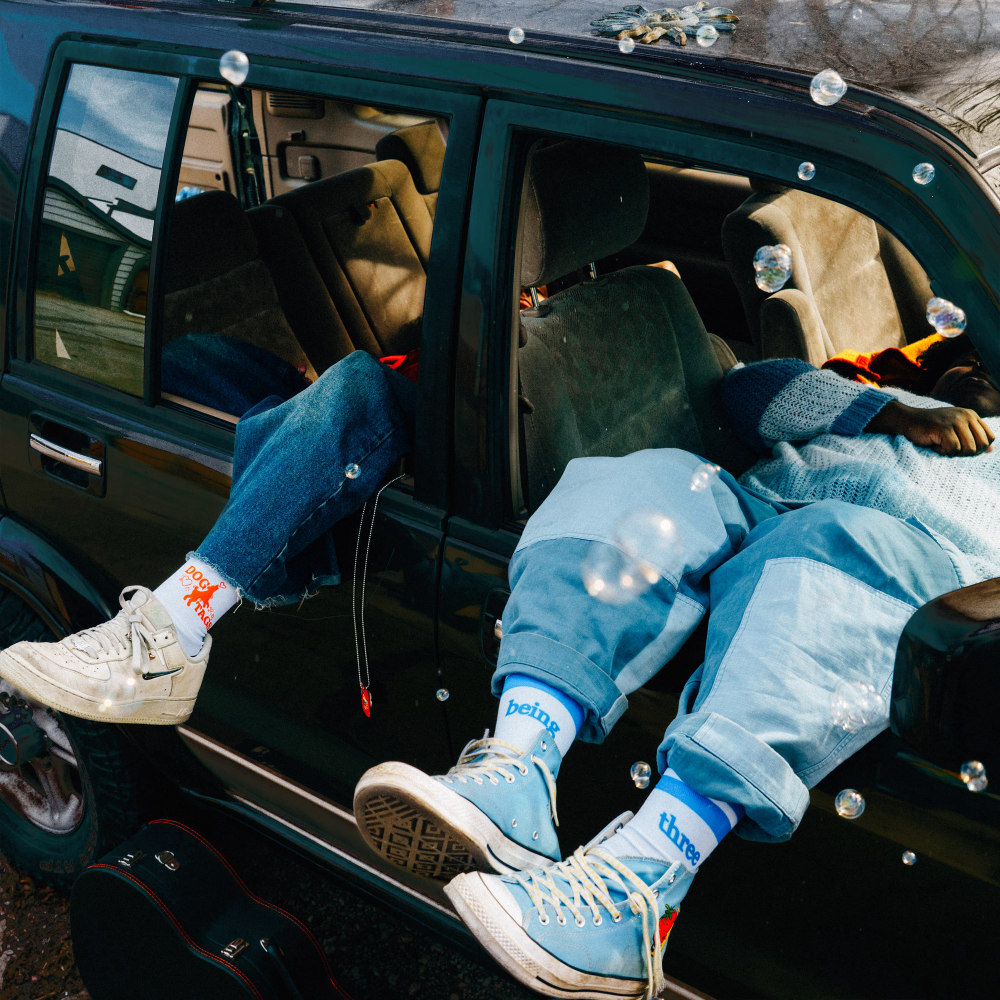 legs hanging out of car windows