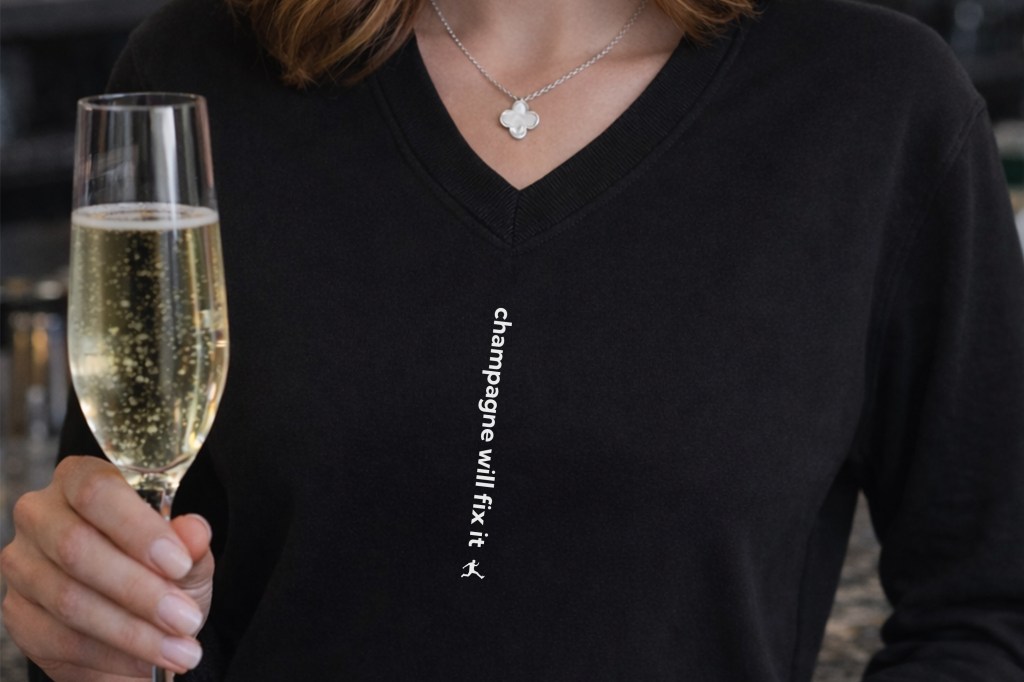 Black shirt with "Champagne will fix it" vertically written on it