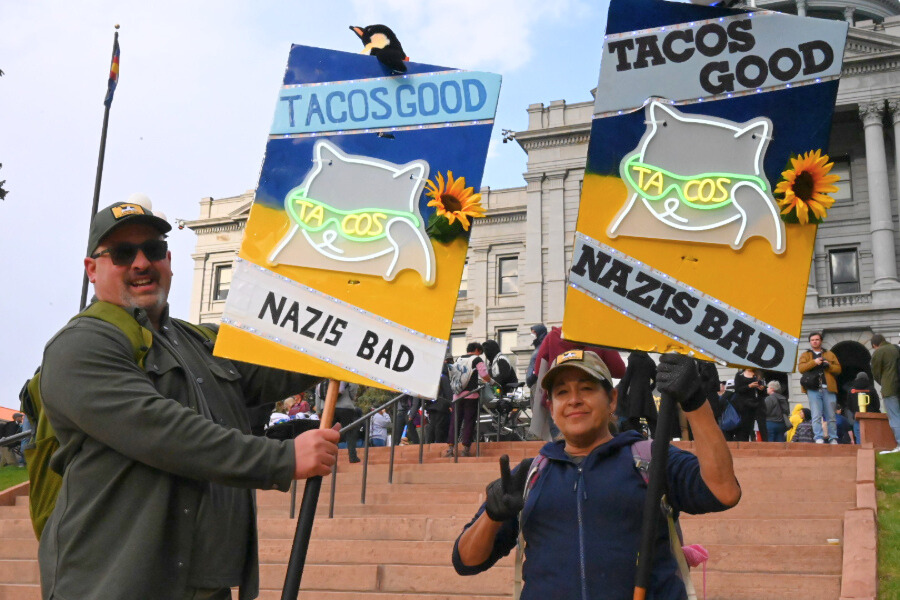 Protesters in Denver hold "Tacos Good, Navis Bad" signs at State Capitol protest