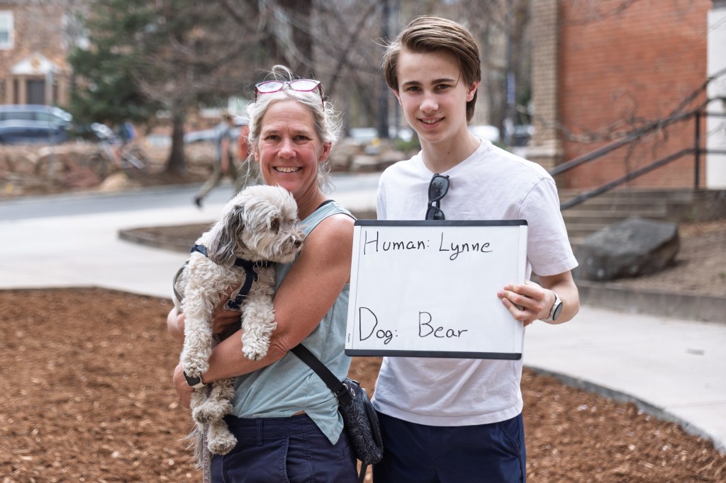 People pose with their dog