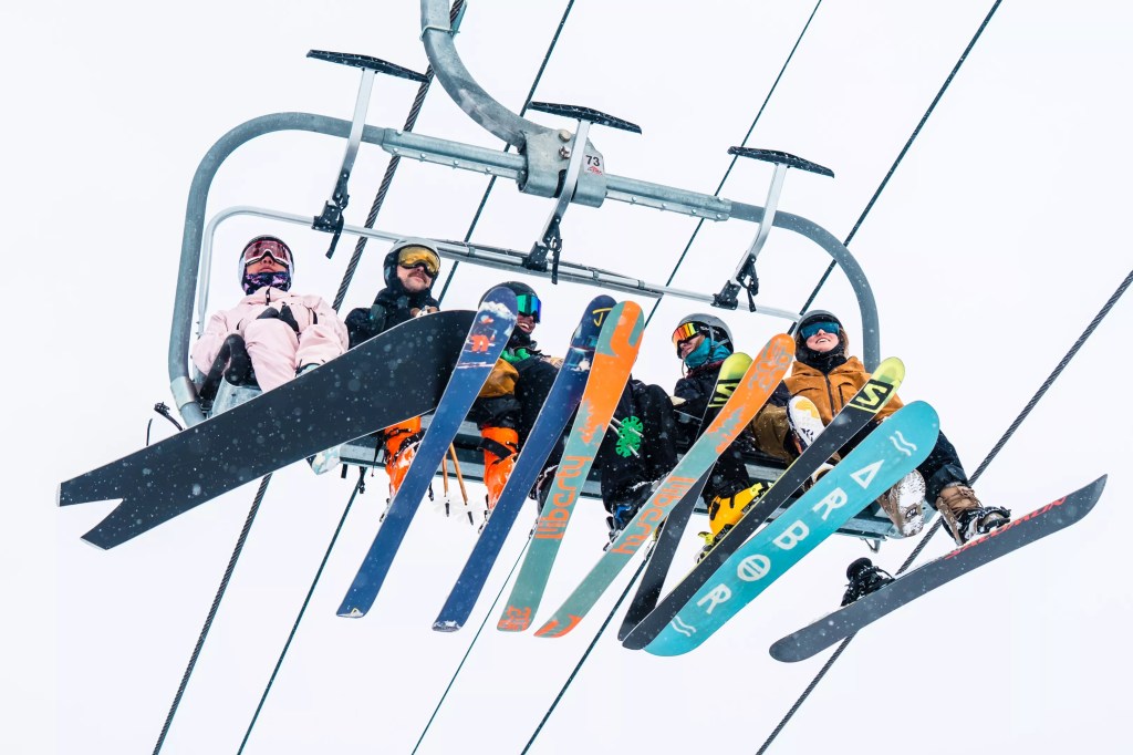 Skiers and snowboarders on a lift at Copper Mountain