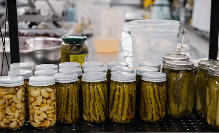 a shelf full of preserving jars