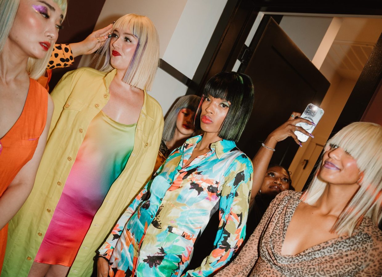 models in blond wigs and colorful attire