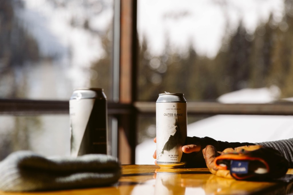 A can of Outer Range beer on a table inside the brewery's Frisco taproom