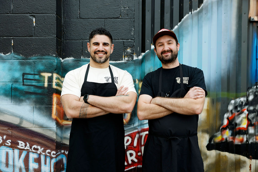 two chefs posing with arms crossed