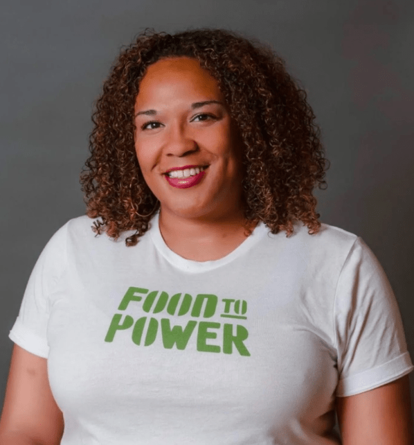 headshot of a woman in a "food to power" t-shirt