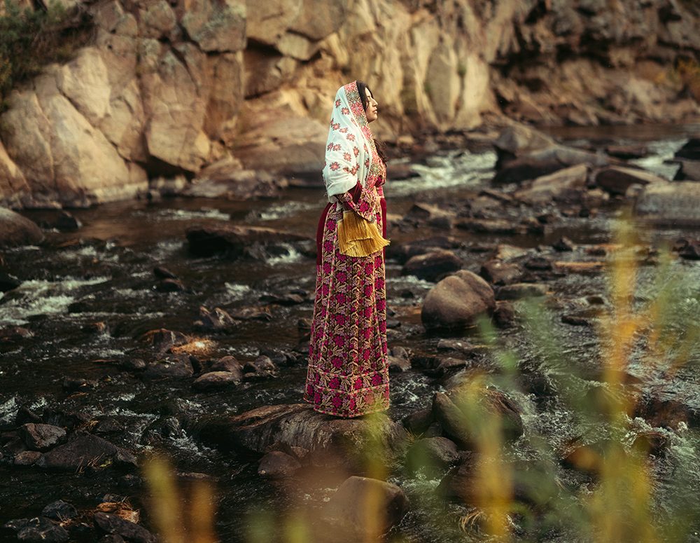 A woman stands in a river