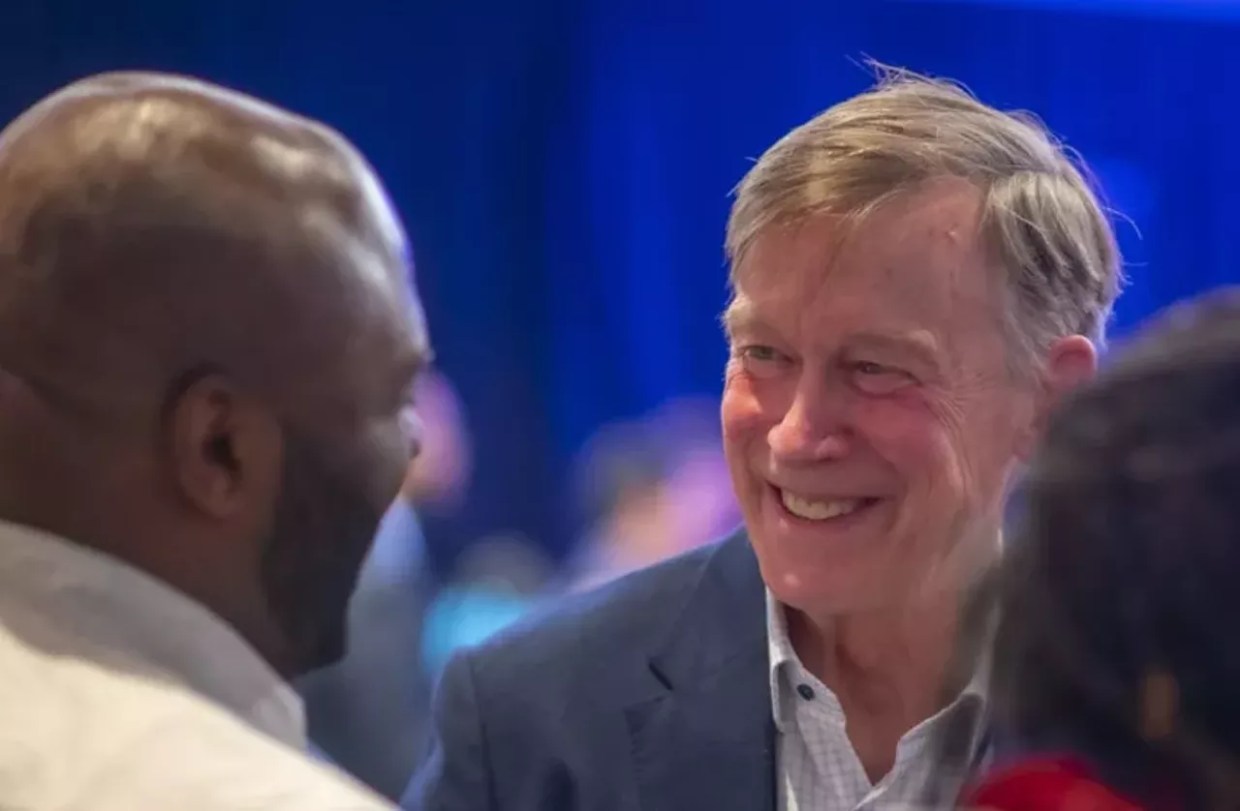 U.S. Senator John Hickenlooper speaks to a constituent