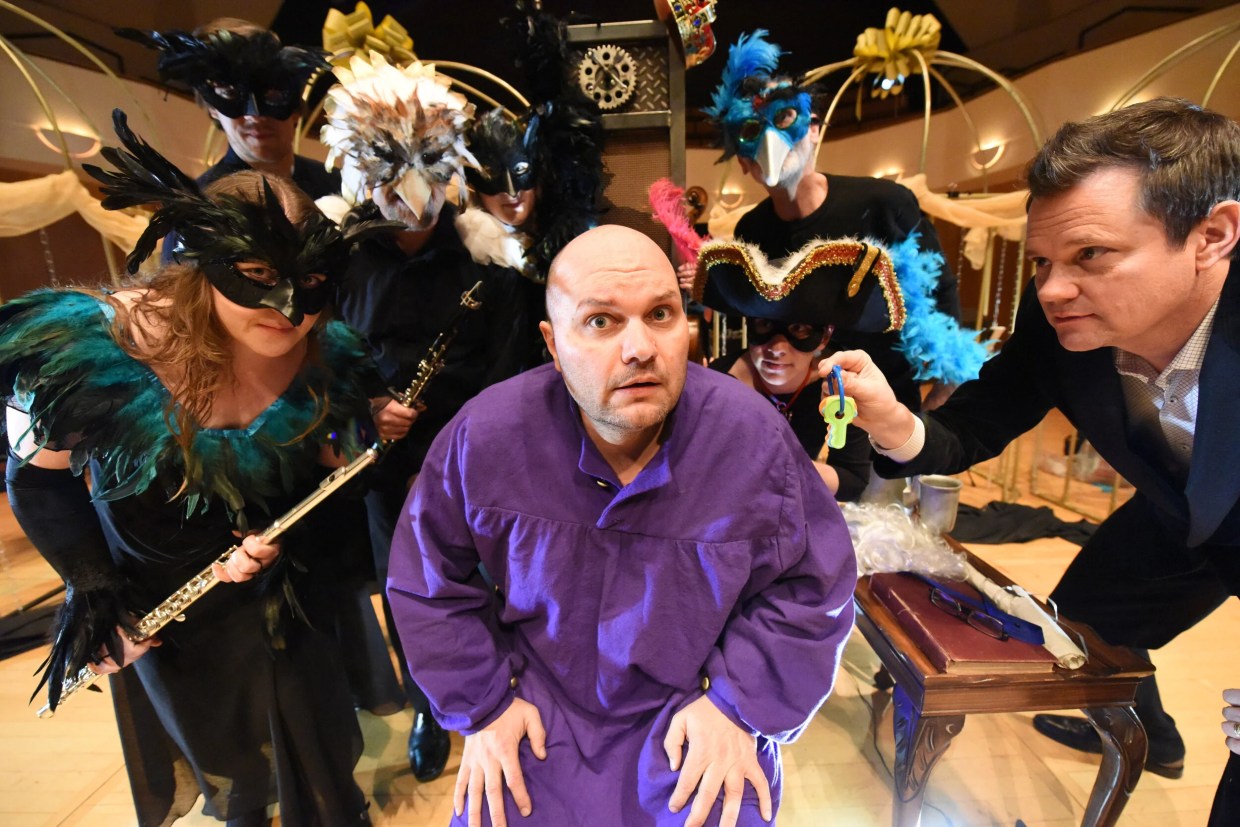 man in purple shirt in front of orchestra