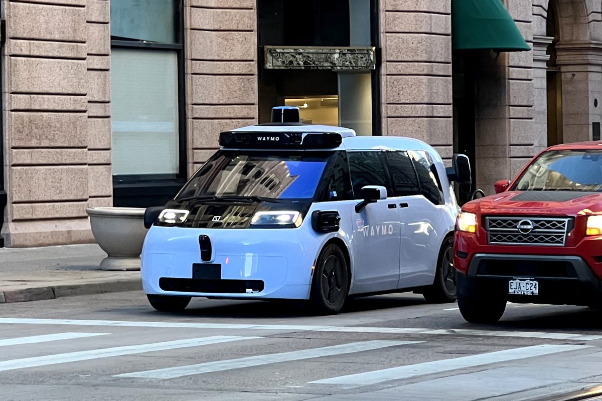 a waymo vehicle stops at a red light in downtown denver