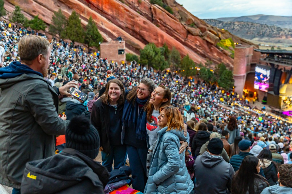 Concertgoers huddle together for a group photo at Red Rocks.