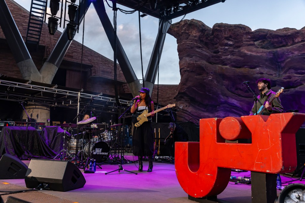 A photo of Joy Crookes performing on stage at Red Rocks.