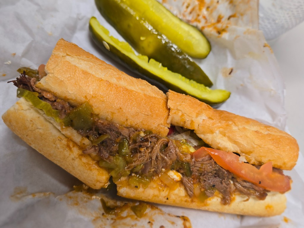 roast beef sub with pickle spears on the side