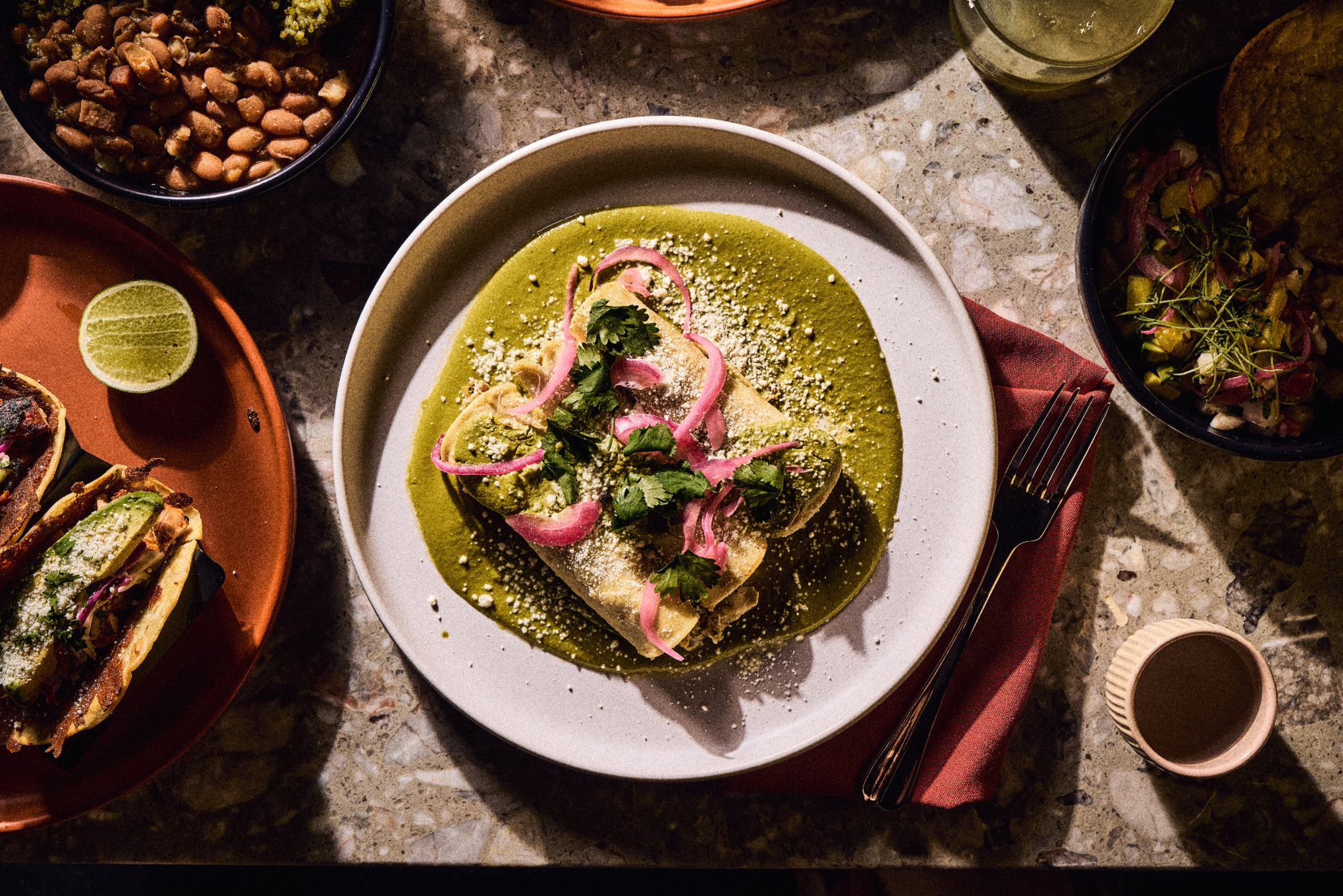 enchiladas smothered with green sauce on a plate