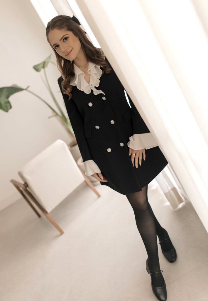 Girl wearing a blazer dress with ruffles