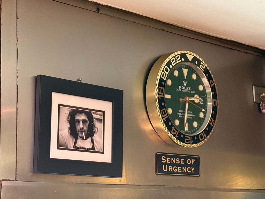 a photo of a famous chef by a clock