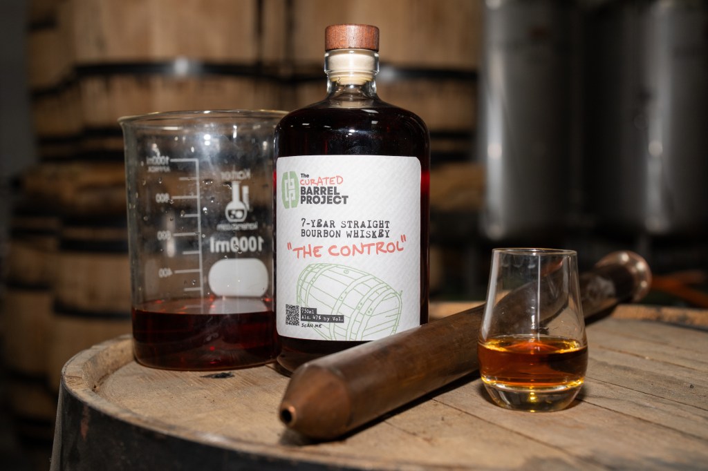 bottle of whiskey on a barrel