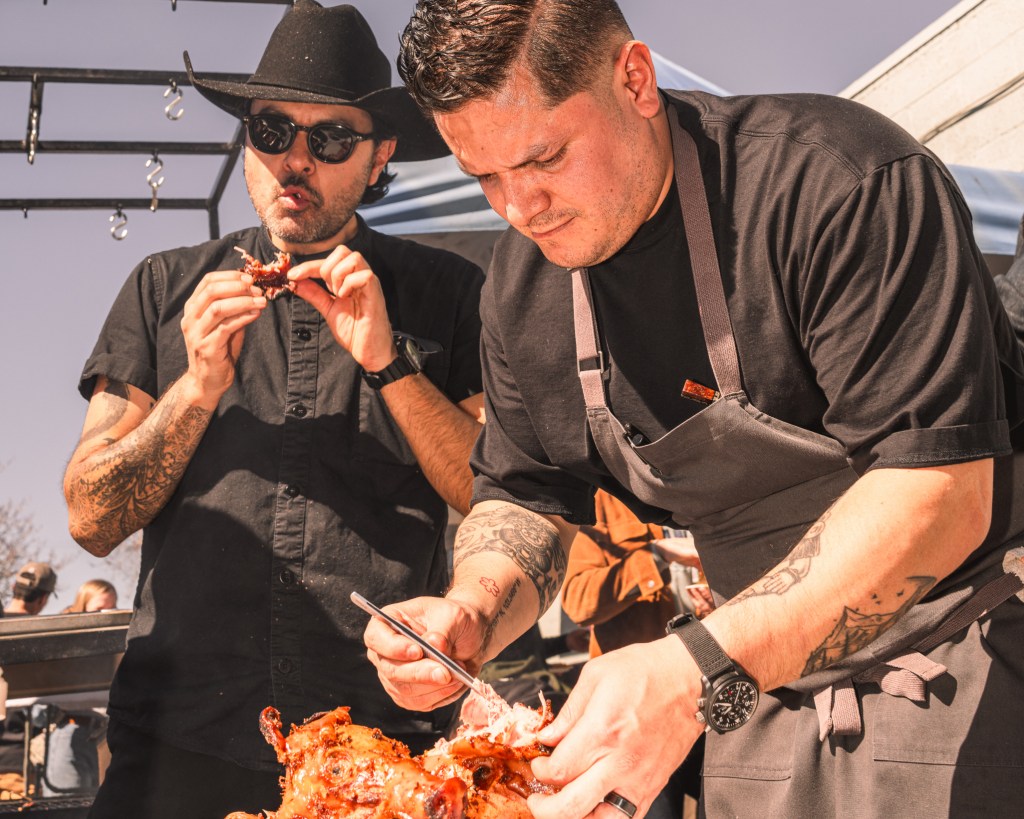 two chefs cooking outdoors