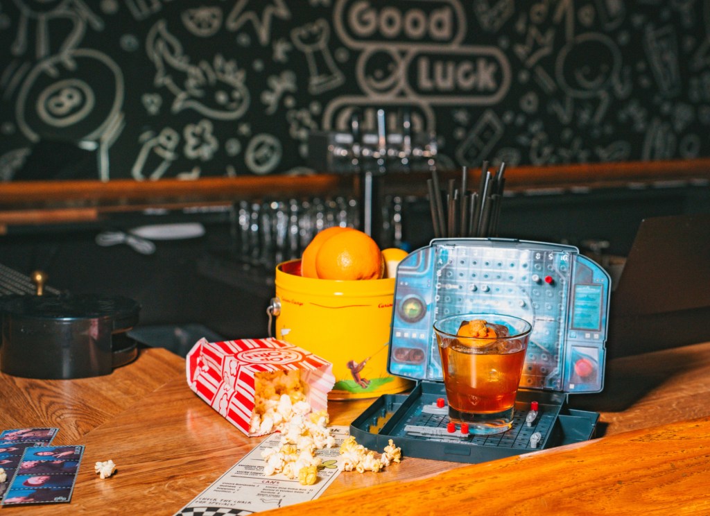 cocktail and popcorn on a bar
