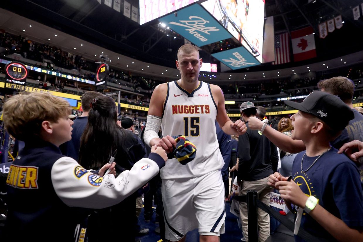 Children and fans greet Nikola Jokic after game one of the playoffs
