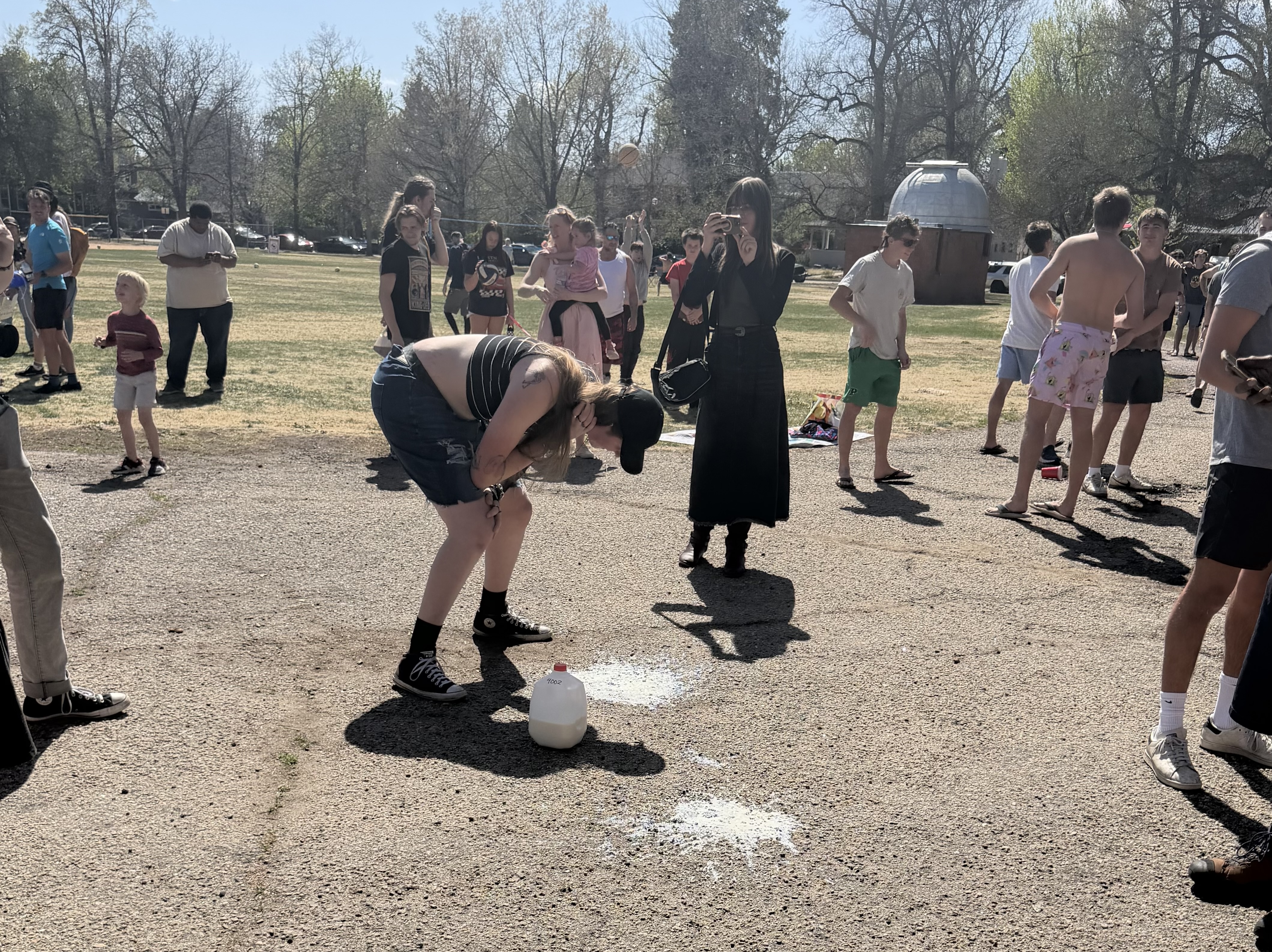a milk chugging competition bends over to puke after drinking too much milk