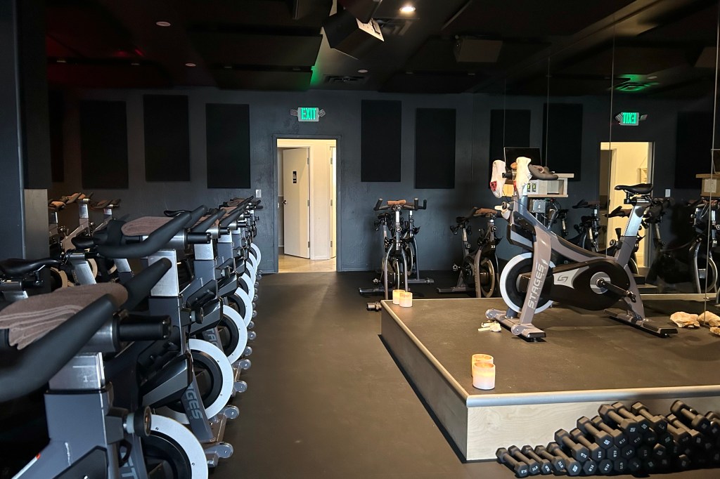 Rows of stationary bikes in the dimly-lit Ritual workout space