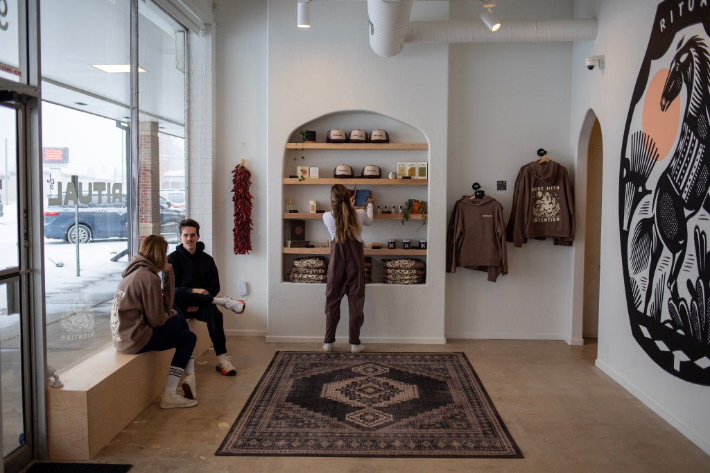 The bright Ritual lobby featuring branded apparel and a large mustang mural