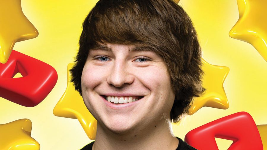 young man smiling in front of yellow background
