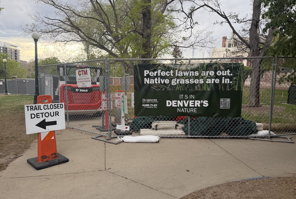 a fence and banner announce the beginning of construction and the closure of portions at Governor's Park