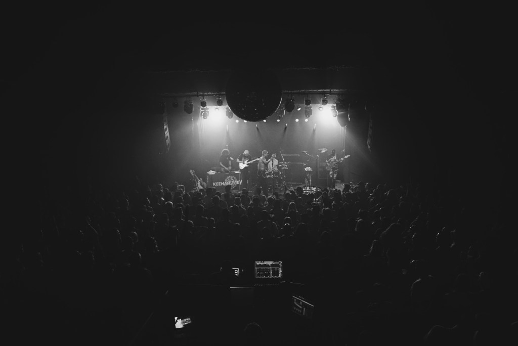 band on stage with crowd