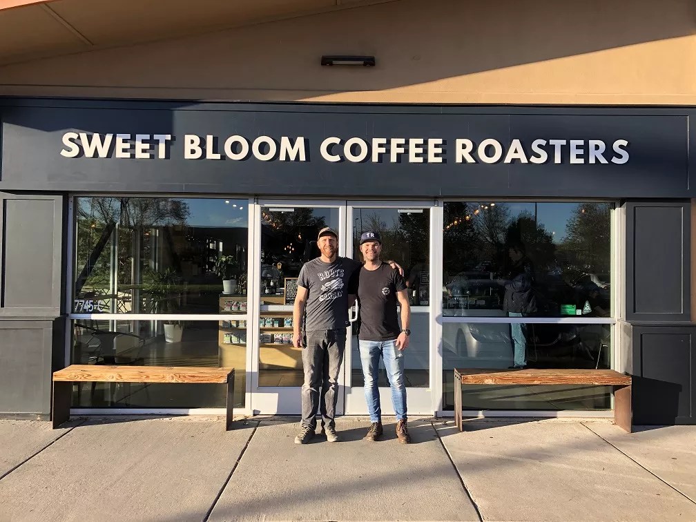 two men in front of coffee shop
