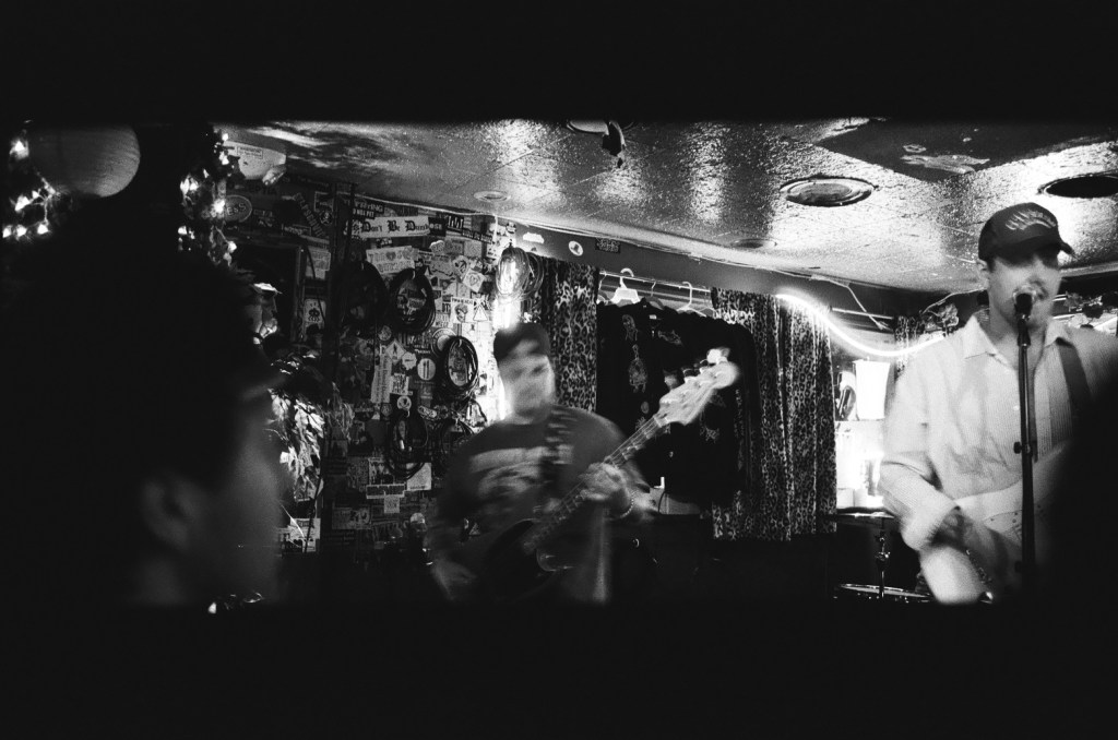 the band waxpool performing at an indoor venue