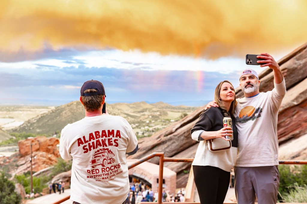 Concertgoers take photos of a rainbow at Red Rocks during the Alabama Shakes show.