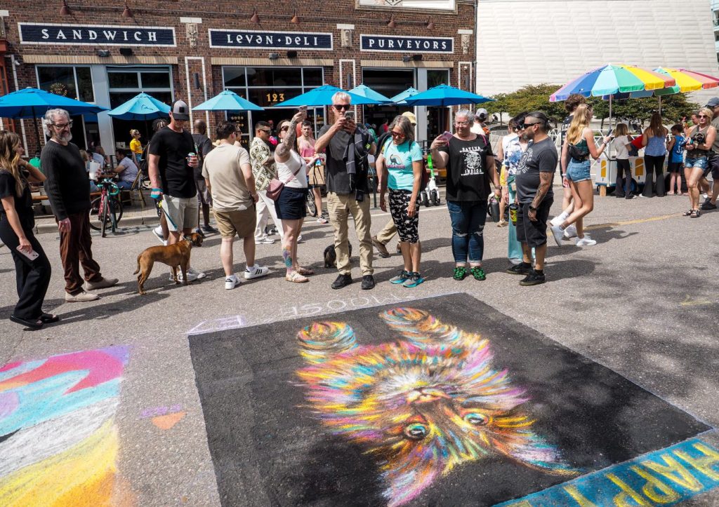 People taking photos of chalk art