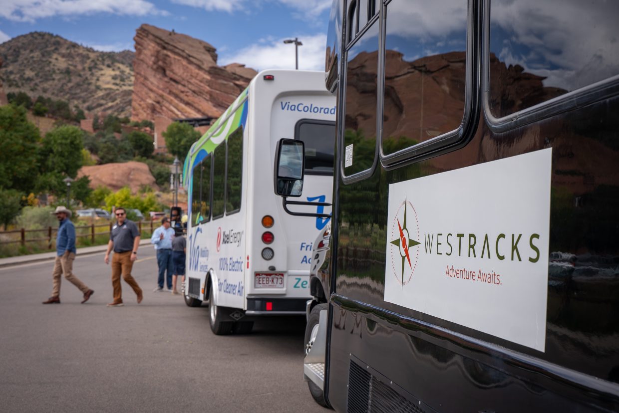 People get off a bus at Red Rocks