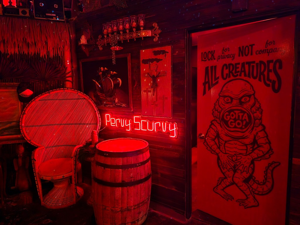 "Pervy scurvy" neon sign in a bar