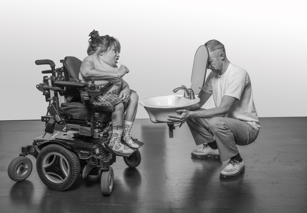 woman in wheelchair next to man