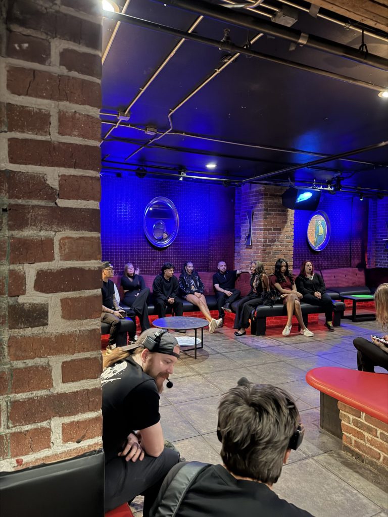 people filming a reality show in an empty club