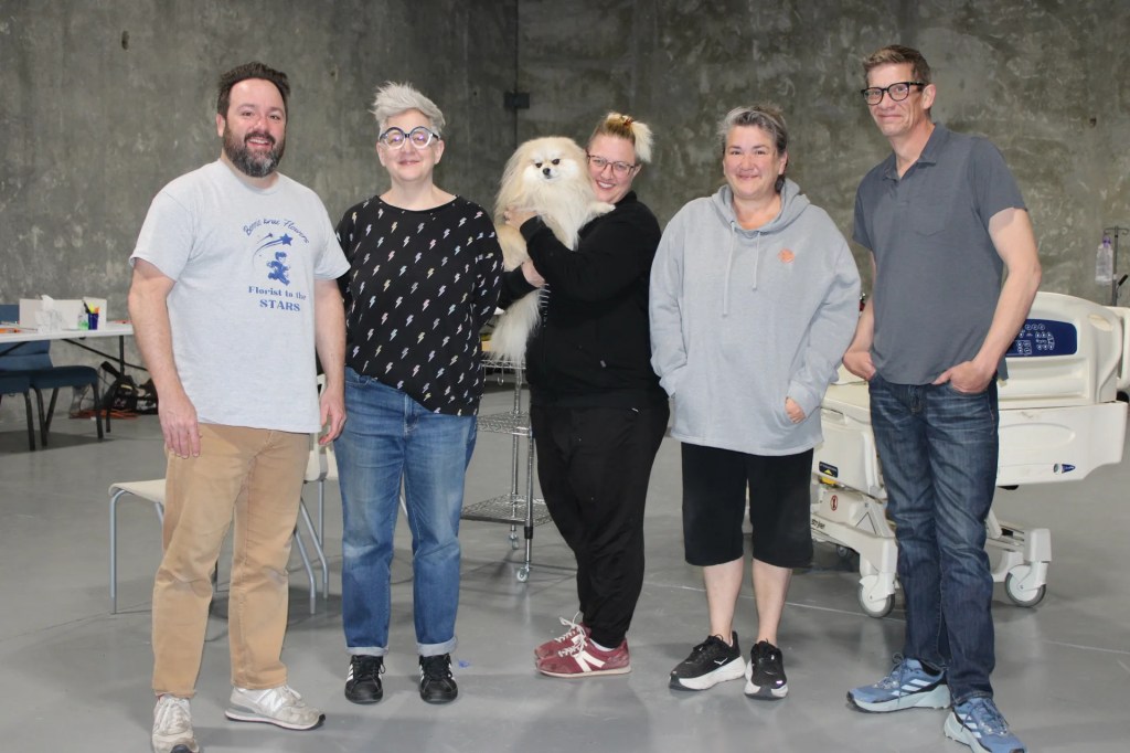Five people pose together