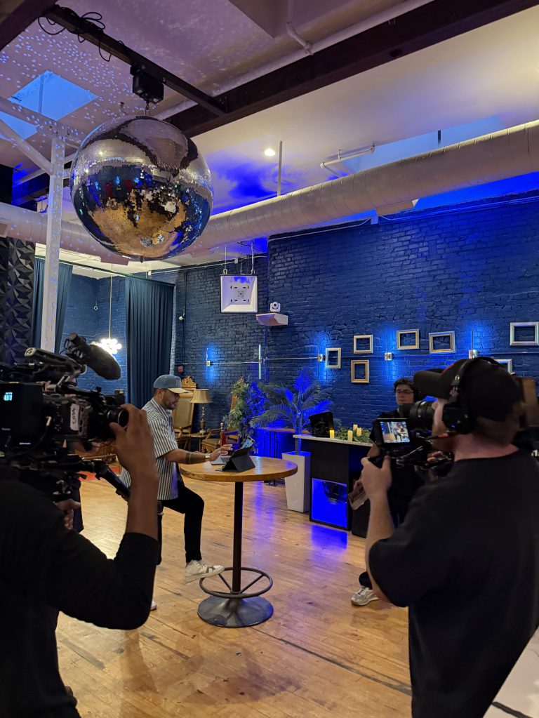 people filming a reality show in an empty club