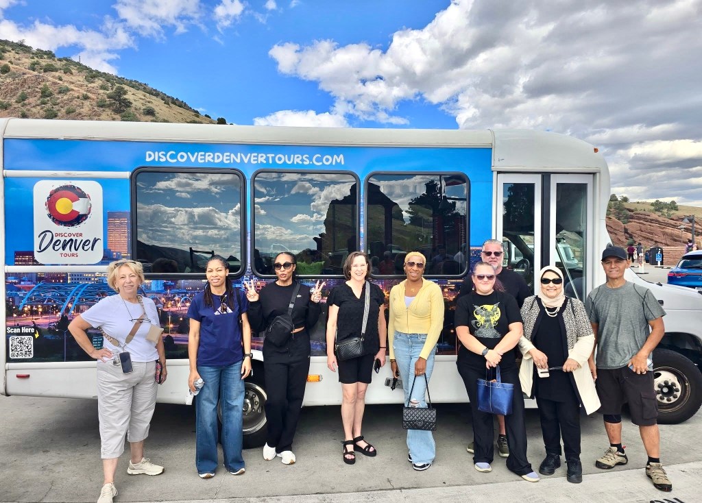 People stand in front of a bus