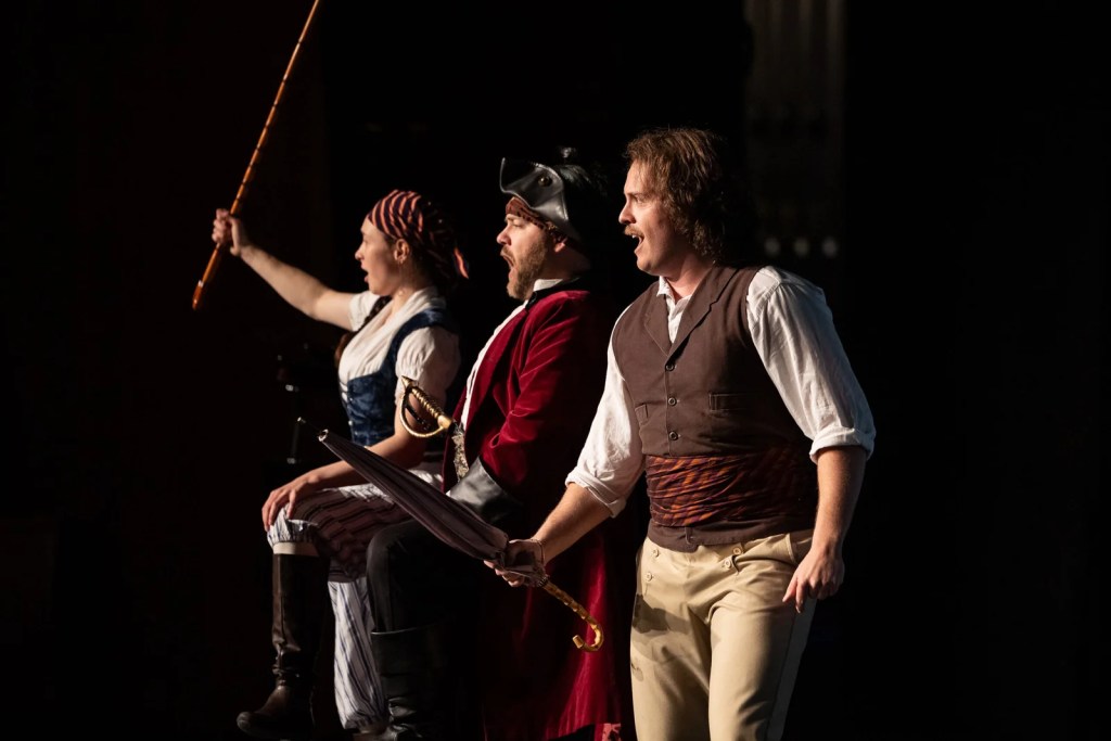 Three opera singers perform