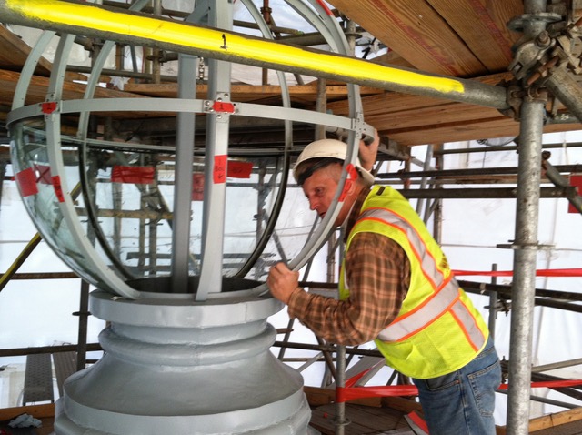 Phil Watkins working to restore the glass globe atop the Capitol building.