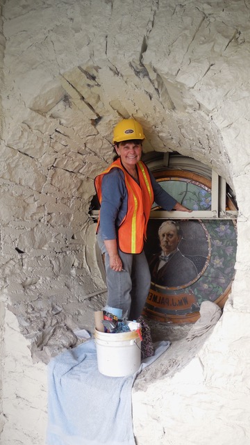 Jane Watkins in the cubby behind the Hall of Fame Rotunda window depicting General William Palmer during Watkins Stained Glass's restoration of the windows.