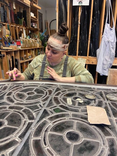 Kitt Watkins works on a window restoration for Evans Memorial Chapel.