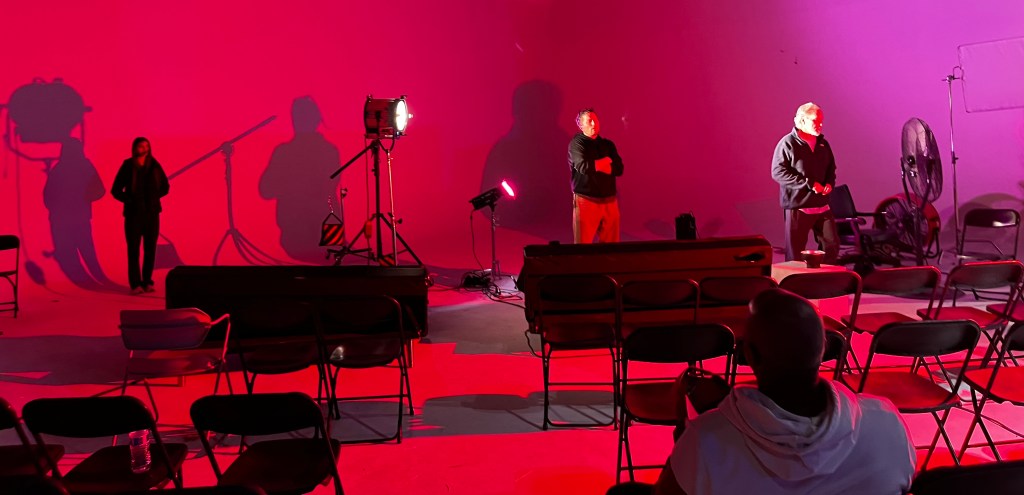 A theater crew sets up for a performance