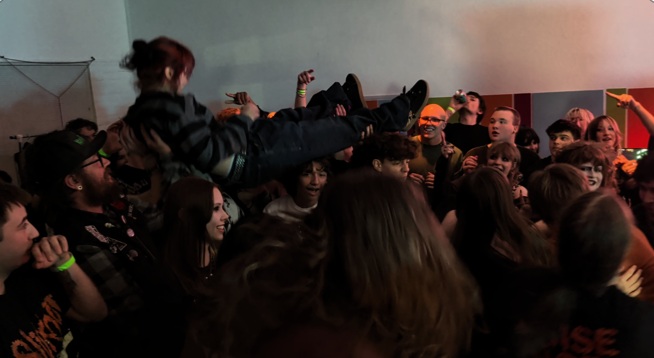 A person crowdsurfing