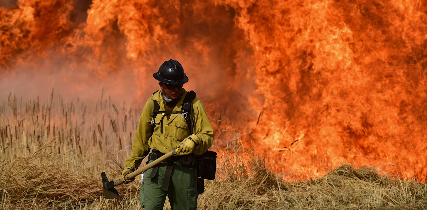 firefighter in front of blaze