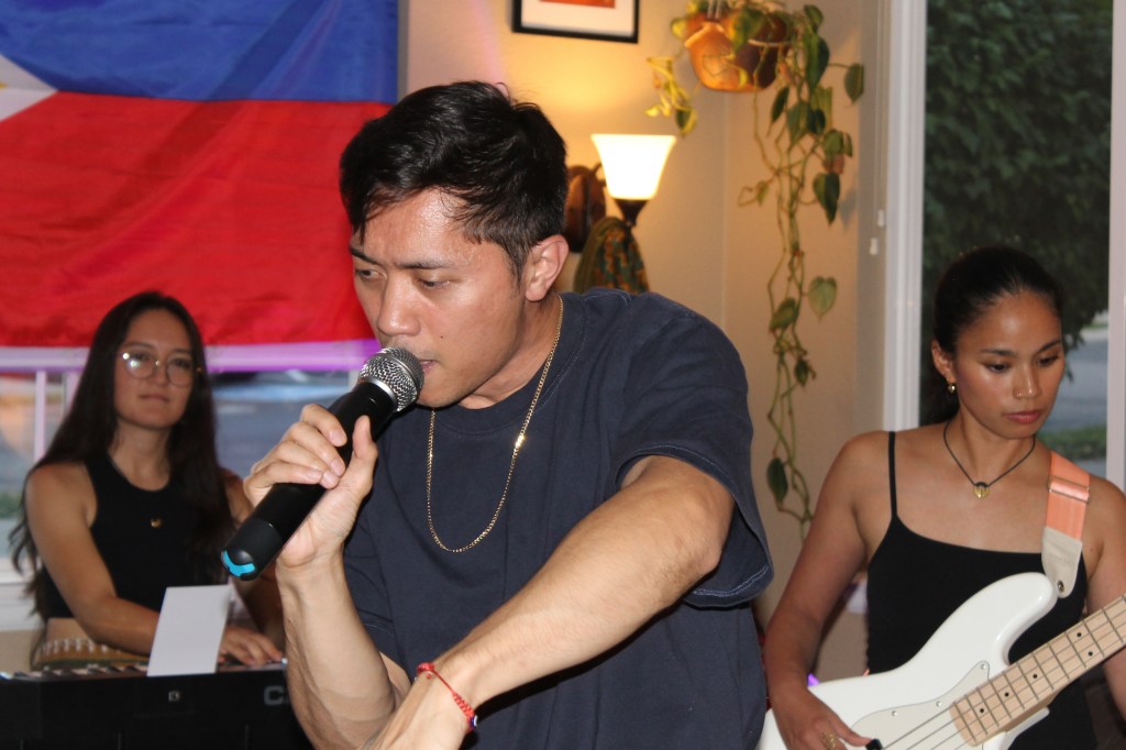 keyboardist, singer and bassist performing