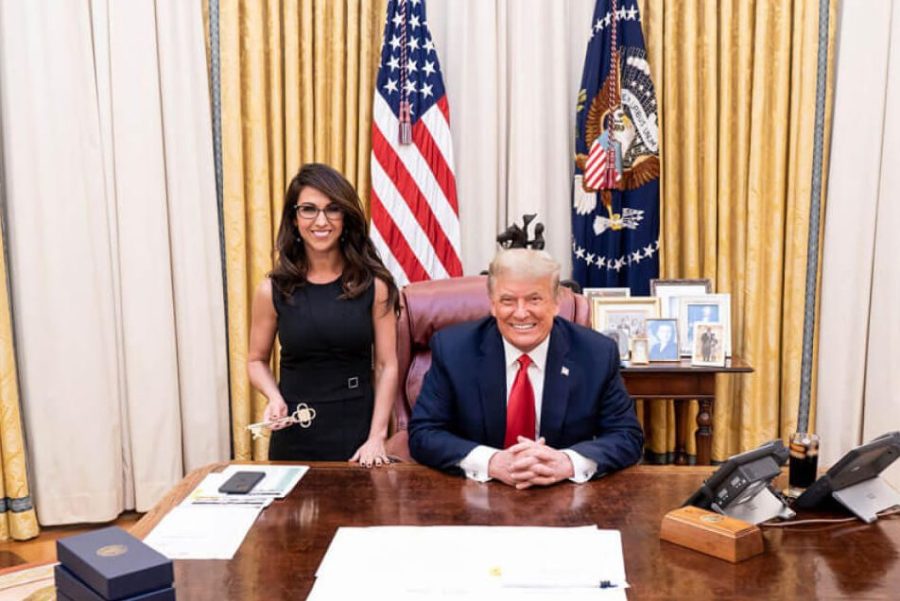 Congresswoman Lauren Boebert stands next to president donald trump, behind his desk in the oval office.